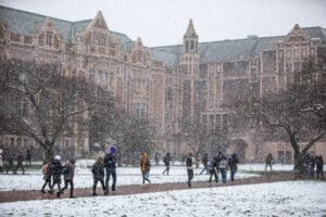 Students walk through the quad on a snowy day.