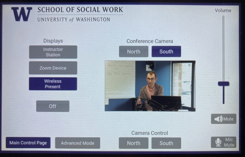 Screenshot of a touchscreen display with various button options shown and a camera view showing a man with glasses.