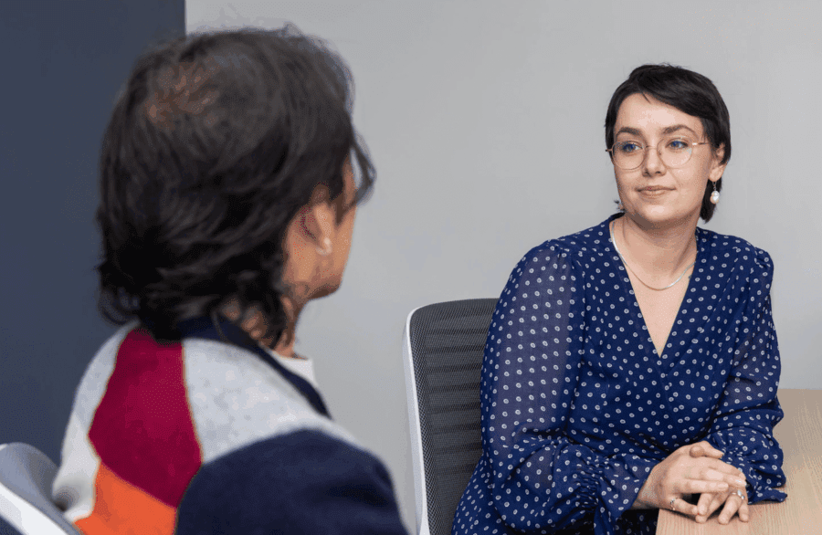 Two students looking at one another in a classroom.