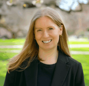 Maya Trachtenberg, Assistant Dean of Advancement, standing outside wearing a black shirt and black blazer.