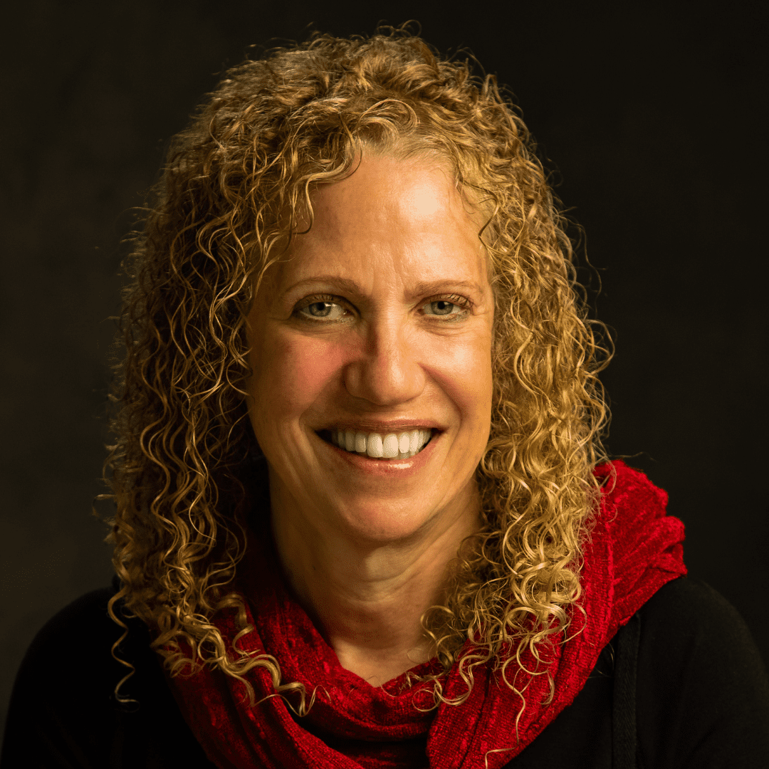 Headshot of Rona Levy, wearing a red scarf.
