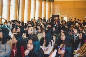 Students sit in an auditorium for a presentation.